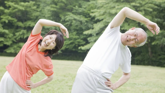 The elderly couple working out while listen to the radio in the park